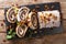 Festive glazed poppy beigli cake with raisins, walnuts close-up on a table. Horizontal top view