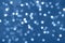 Festive glittering christmas lights. Abstract cement concrete background in trendy monochrome blue and calm color