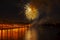 Festive golden fireworks, bright reflection in the lake. Celebration. Abstract holiday background