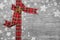 Festive grey wooden christmas background with a red ribbon.