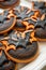 Festive Halloween Cookies Decorated as Black and Orange Bats and Pumpkins on a White Plate