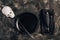 Festive Halloween table setting in a black style. Plate with fork, spoon and knife on a linen napkin. Halloween dinner. Minimal