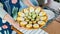 Festive iced cookies in the form of cute chickens on a platter in the hands of a woman in an apron. Family baking ideas with kids