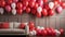 Festive interior with red, pink, and white balloons and a beige sofa