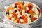 Festive Italian cauliflower salad with giardiniera, olives and anchovies close-up on a plate. Horizontal