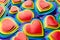 Festive lgbt Valentines day background - multicolored valentines hearts, pattern, top view.