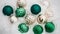 Festive long banner. beautiful green and gold Christmas toy in the shape of a ball on white snow. Christmas decoration pattern,