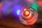 Festive luminous Christmas ball on a cozy wooden surface. Colorful magic. Close-up