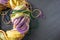 Festive Mardi Gras beads drape over a green, gold and purple King Cake with copy space; celebrations