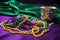 festive mardi gras beads on a purple cloth