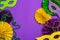 Festive Mardi Gras masquerade purple background. Fat Tuesday carnival, masks, beads, traditional decor