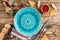 Festive Mexican table setting. Plate and cutlery with colorful napkin on rustic wooden background. Flat lay