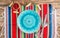 Festive Mexican table setting. Plate and cutlery with colorful napkin on rustic wooden background. Flat lay