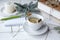 A festive mock up photo with a fir twigs, an opened note book, an old book, a pencil, cones, a candle and decation elements