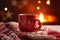 Festive mug by the fireside, Hot drink in a red knitted mitten