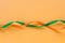 Festive orangeand green ribbon waves on orange background