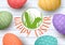 Festive ornamented easter eggs on white wooden background. Happy Easter. badge with rabbits ears silhouette.