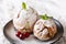 Festive pastry: biscuit snowball with mint and cherries closeup