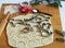 Festive pastry christmas background. Home cooking. Making Christmas animal cookies and cookie cutters on a kitchen board among fir