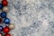 Festive patriotic USA American Christmas background featuring ornaments in red white and blue colors on blue marble background