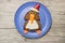 Festive penguin made as sandwich on blue plate