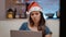 Festive person working with laptop and watching television