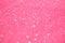 Festive pink background with copy space. Abstract sparkling lights, shiny holiday background