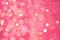 Festive pink background with copy space. Abstract sparkling lights, shiny holiday background