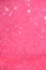 Festive pink background with copy space. Abstract sparkling lights, shiny holiday background