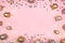 Festive pink background with gold and silver stars and Christmas balls.