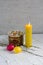 A festive postcard with Easter symbols: a painted egg, sweet cake, willow branches and a burning candle.