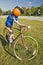 A festive pumpkin rides a bicycle along Crawford Notch, New Hampshire