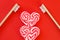 Festive red background. Sweet heart candy. And two toothbrushes symbol of love. Valentine\\\'s Day. Ideas of gifts. Flat lay