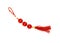 Festive red knot with tassel, top view photo. Asian holiday symbol. Red silk knot isolated. Chinese New Year decoration