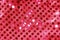 Festive red synthetic fabric with round shiny sequins