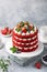 Festive  Red Velvet cake on white cake stand