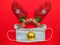 Festive reindeer muzzle with shiny horns, Christmas ball and face mask