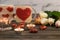 A festive romantic concept for Valentines Day with heart-shaped sweets, candles and cute cups with hearts in the background, as