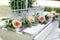 Festive rustic style decorations fresh flowers and white birdcage on a wooden box. Sunny summer day