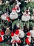 Festive scene of a decorated Christmas tree adorned with hanging Santa Claus decorations