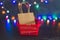Festive season shopping bag and basket with multicolour Christmas string lights bokeh