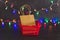 Festive season shopping bag and basket with multicolour Christmas string lights bokeh