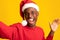 Festive Selfie. Cheerful Black Guy In Santa Hat Taking Self-Portrait, Celebrating Christmas