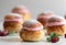 Festive Semlor or Semla : Traditional Scandinavian Buns flavored with cardamom filled with almond paste & raspberry whipped cream