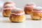 Festive Semlor or Semla : Traditional Scandinavian Buns flavored with cardamom filled with almond paste & raspberry whipped cream