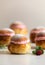 Festive Semlor or Semla : Traditional Scandinavian Buns flavored with cardamom filled with almond paste & raspberry whipped cream