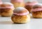 Festive Semlor or Semla : Traditional Scandinavian Buns flavored with cardamom filled with almond paste & raspberry whipped cream