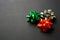 Festive shiny green, orange and silver gift bows for a present wrapping. Black background. Party decorations.