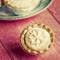 Festive shortcrust pastry mince pies. A sweet mince pie, a traditional rich festive food on red wooden background.
