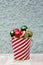 Festive Small Balls Collected in Striped Bucket for Christmas